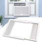 White window AC side panel kit installed in a window frame with accordion filler