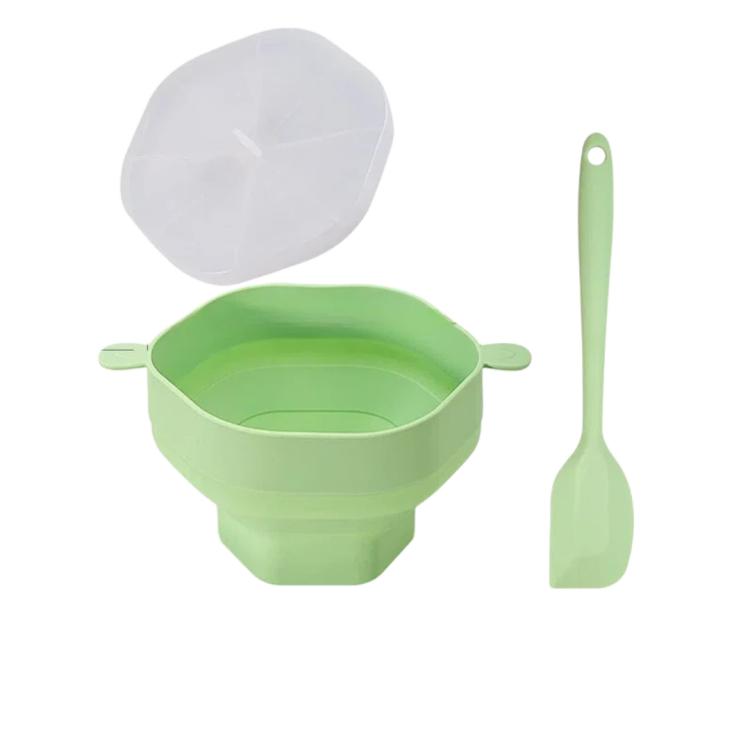 Green microwave popcorn popper bowl with clear lid and green silicone spatula