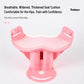 Pink pelvic floor trainer with wide, cushioned seat and textured grip pads on sides