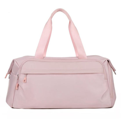 Pink water-resistant sports gym bag with top handles and zip front pocket