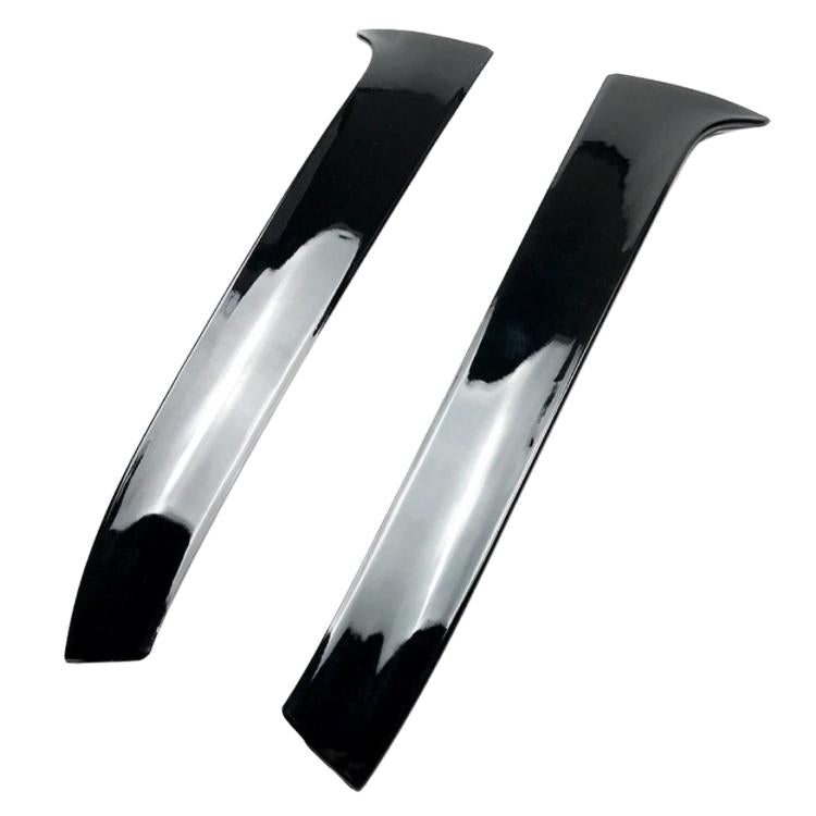 Two glossy black rear spoiler trim fins with a curved aerodynamic profile