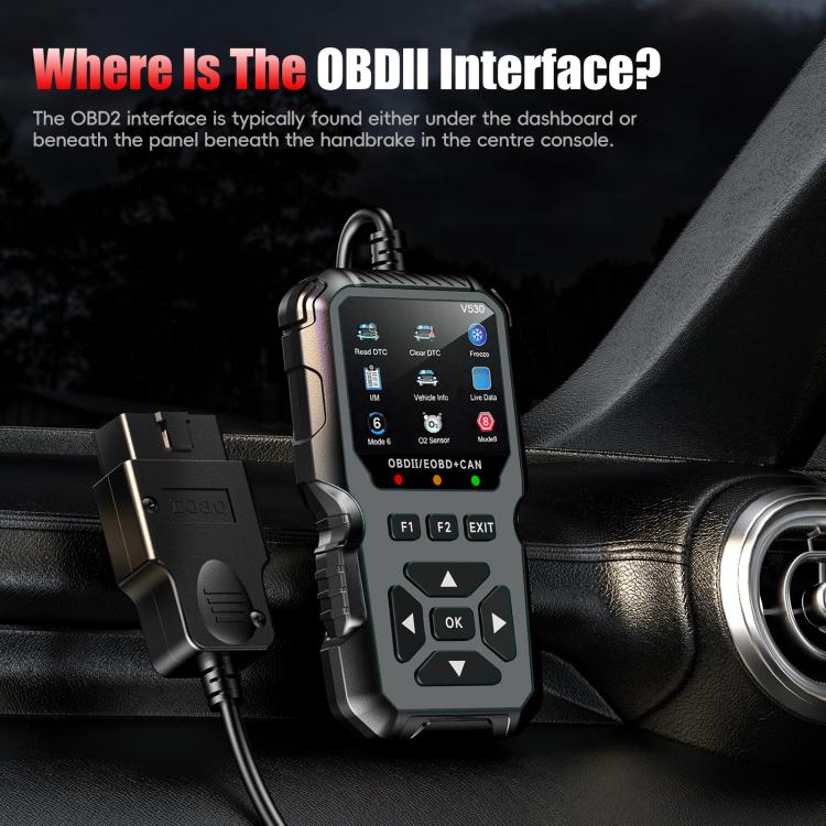 Black OBD2 scanner held near car interior console with attached cable