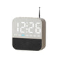 Light gray digital LED alarm clock radio with white time display and day-of-week lights