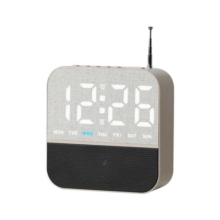 Light gray digital LED alarm clock radio with white time display and day-of-week lights