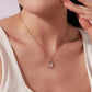 Crescent moon and star pendant necklace on a silver-tone chain, worn at neckline