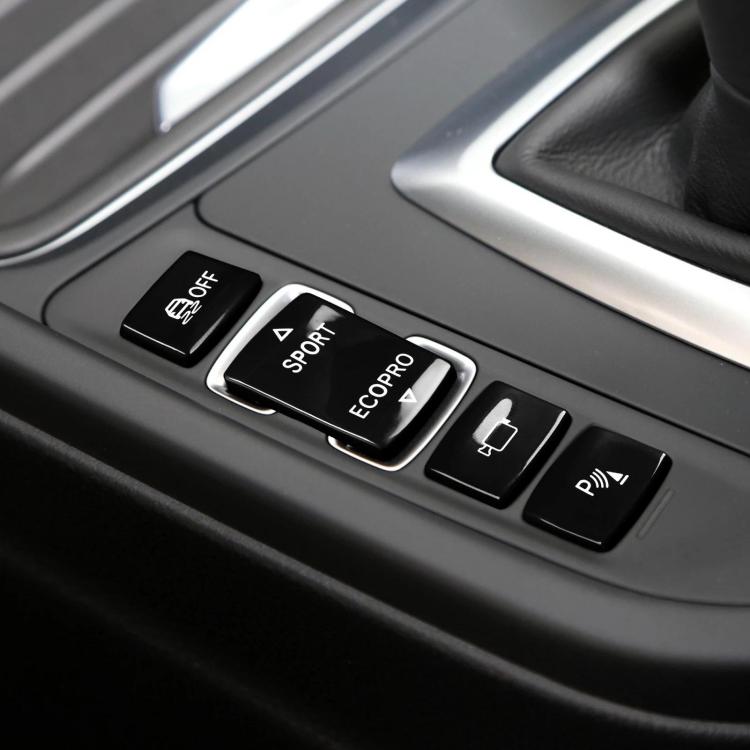 Car gear shift switch buttons set with black caps and white icons on center console