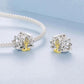 Two lotus yoga charms with seated figure, silver-toned metal with gold center