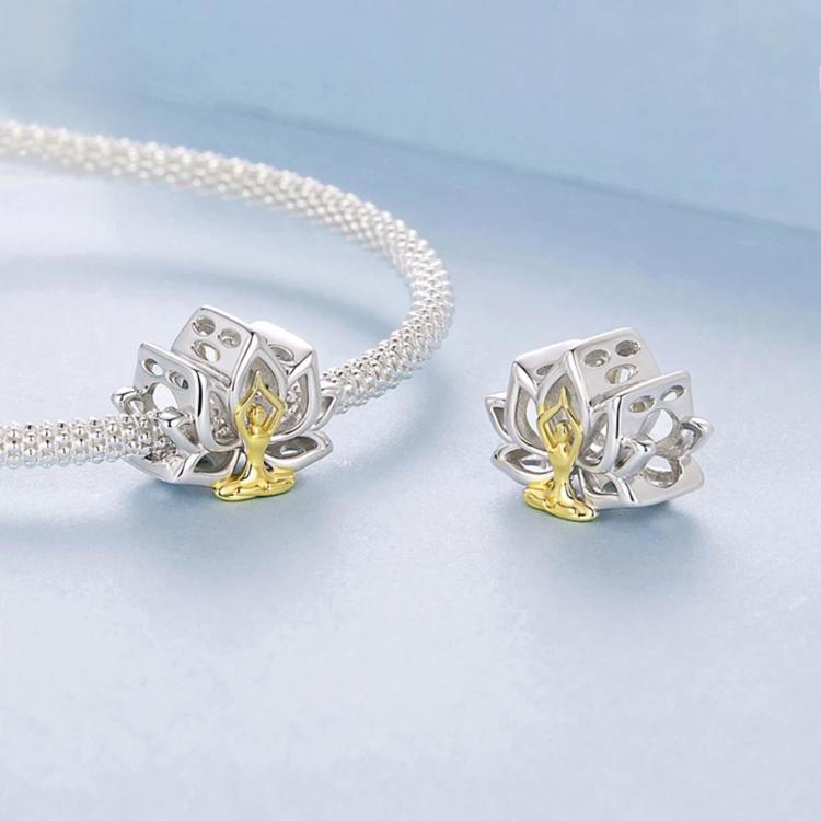 Two lotus yoga charms with seated figure, silver-toned metal with gold center