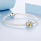 Silver bead bracelet with lotus yoga charm featuring seated figure in gold
