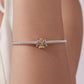 Lotus yoga bead bracelet on wrist, silver chain with gold-and-silver lotus charm