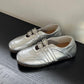 Women's silver square-toe ballet flats with double buckle straps, side-by-side pair view.