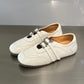 Women's white ballet flats with square toe and double buckle straps, low-profile design.