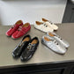 Set of women's ballet flats in red, black, white, and silver with double buckles