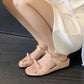 Pink square-toe slide sandals with one strap on bare feet