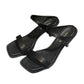 Black square-toe slide sandals with one strap, textured finish and block heel
