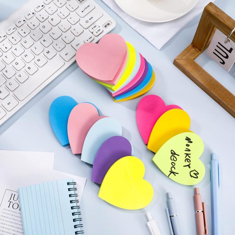 Stacked shaped sticky notes with heart and shirt shapes in pink, blue, and rainbow colors