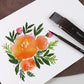 Watercolor brush set with dark bristles and birch wood handles beside floral watercolor