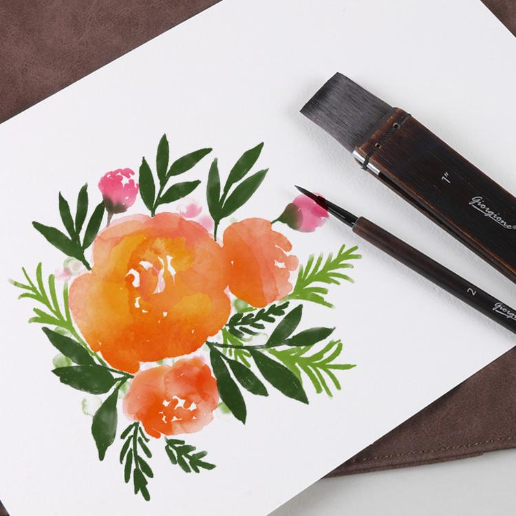 Watercolor brush set with dark bristles and birch wood handles beside floral watercolor