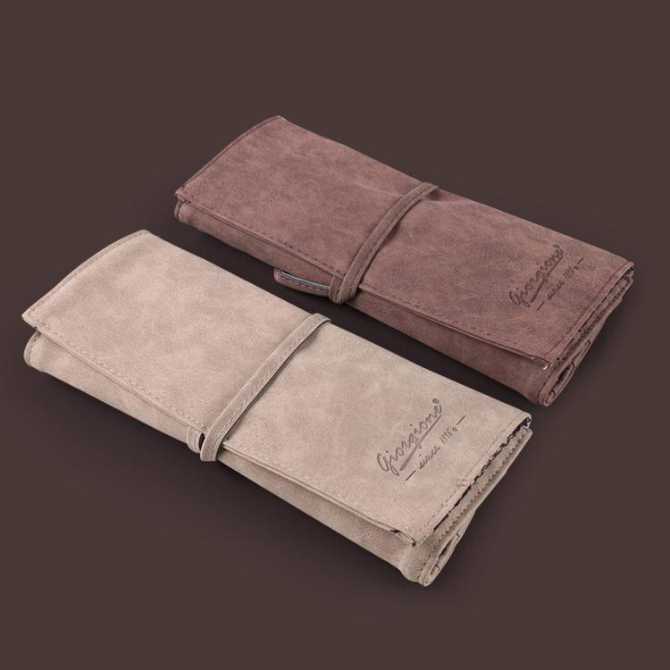 Folded brush roll cases in light and dark fabric for watercolor brushes
