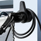 Black EV charger holster on wall with charging cable plugged in
