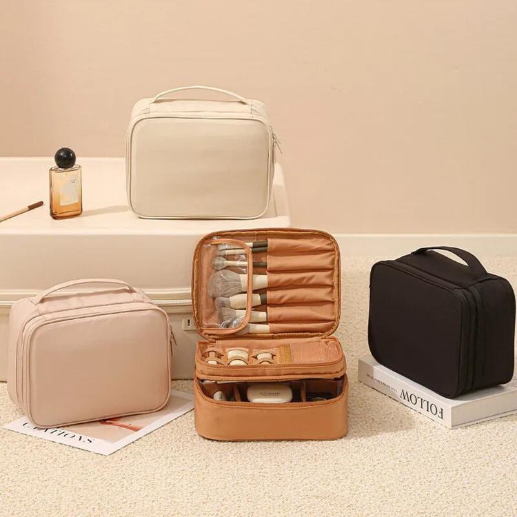 Travel makeup organizer bags in beige, tan, and black, each with compartment dividers