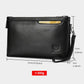 Black leather wristlet clutch bag with wrist strap, front emblem, and zip closure.