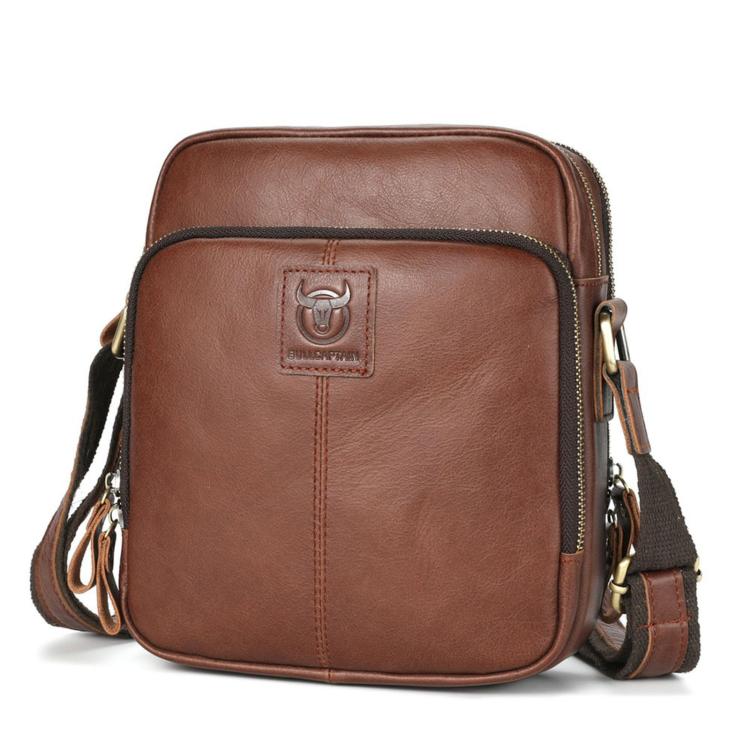 Men's brown leather crossbody bag with zip top and front logo patch.