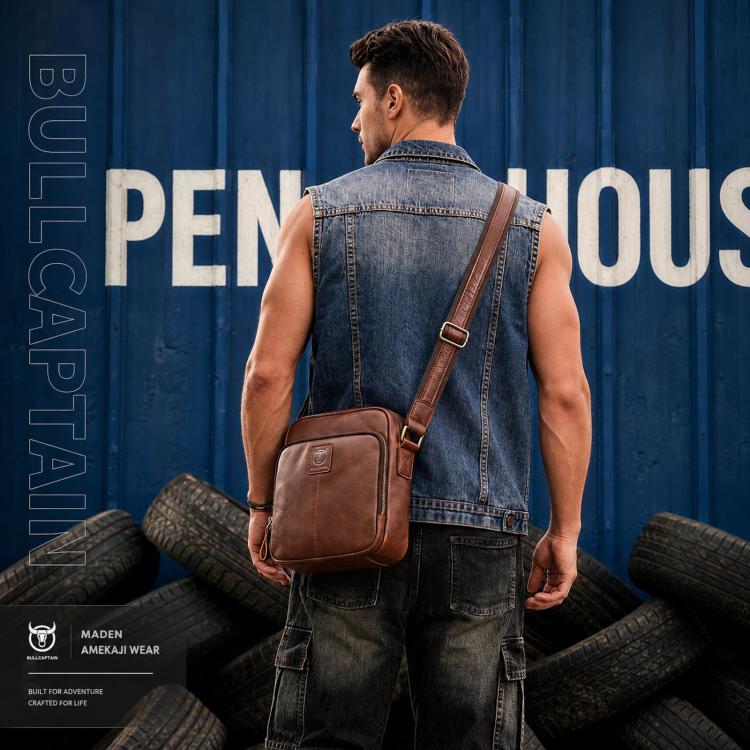 Men's brown leather crossbody bag worn across shoulder with adjustable strap.