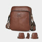 Brown leather crossbody bag with front logo emblem, zip top, and adjustable shoulder strap.