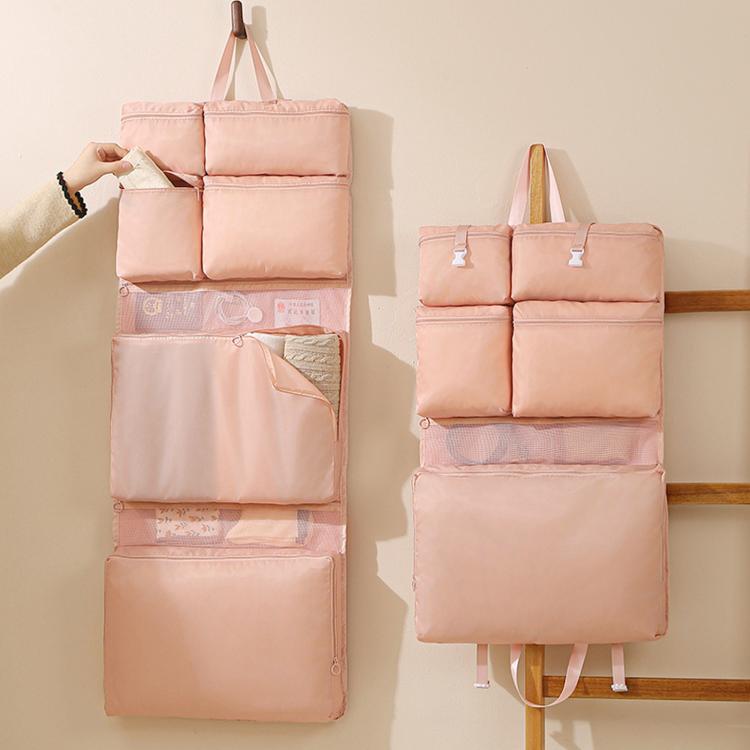 Hanging travel clothes organizer bag, pink with multi-compartment layout and hanging handle