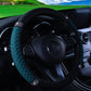 Quilted leather steering wheel cover with rhinestone trim, teal/green
