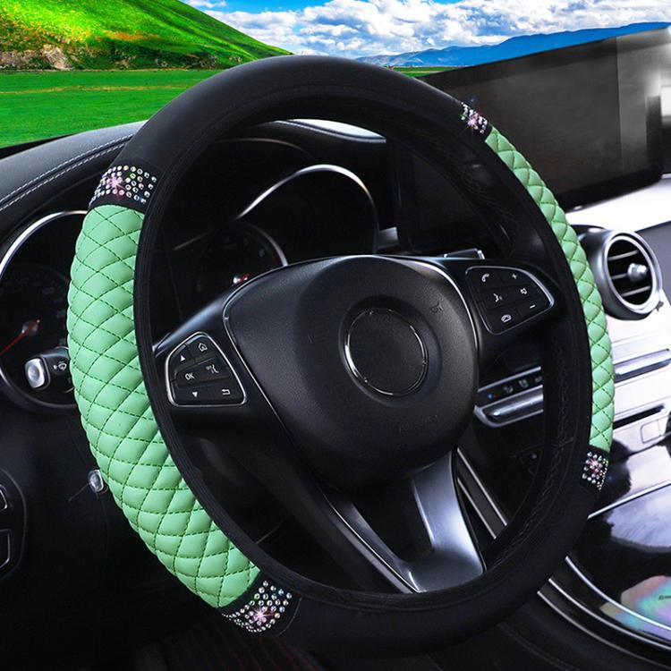 Green quilted steering wheel cover with black edge and rhinestone studded trim