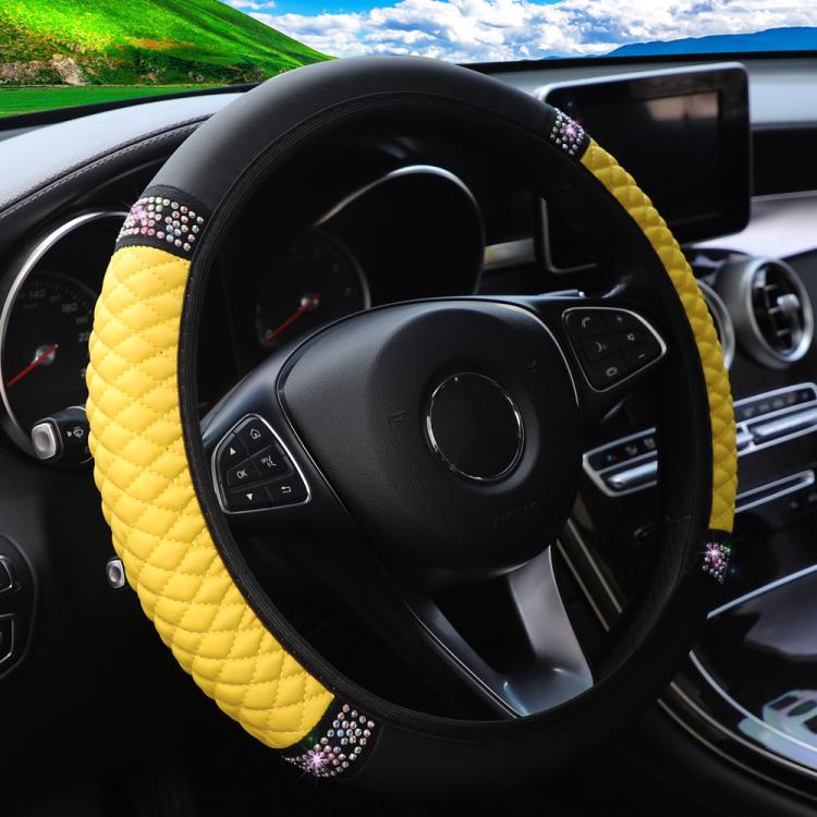 Yellow quilted steering wheel cover with black edge and rhinestone studded band