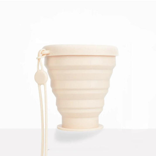 Apricot collapsible silicone travel cup with screw-on lid and hanging lanyard loop