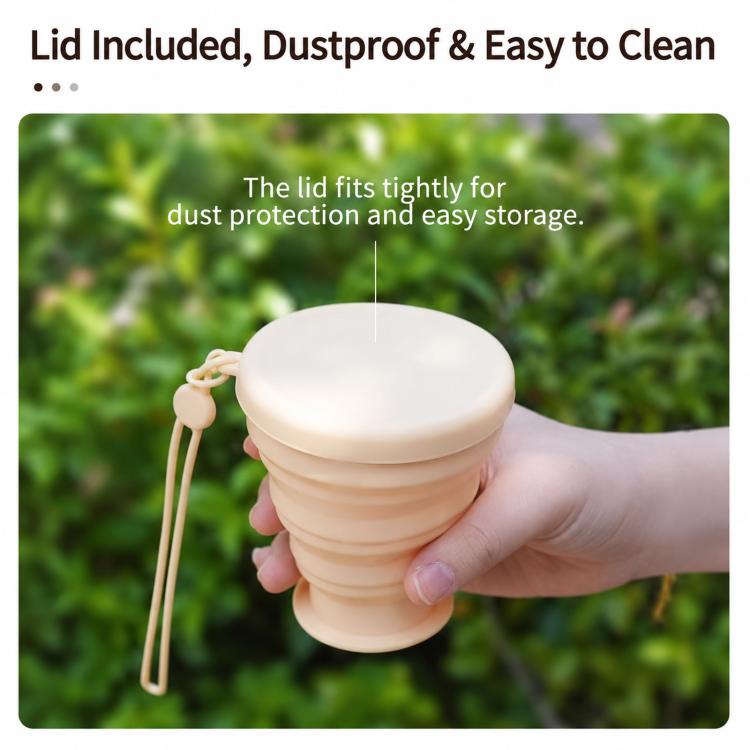 Apricot collapsible silicone cup with white lid and lanyard, held in a hand