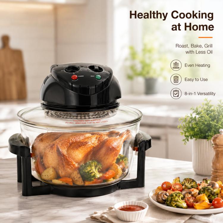 Black 20L air fryer on kitchen counter with clear glass bowl and roast chicken