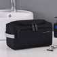 Black zippered travel toiletry bag with two front compartments and carry strap