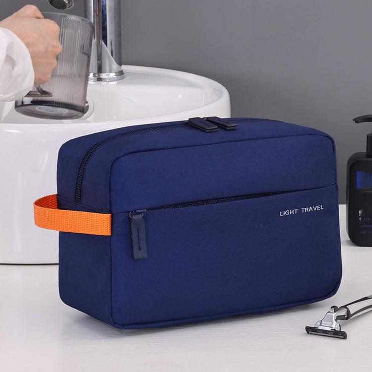 Navy blue water-resistant mens toiletry bag with orange strap detail and zip pockets