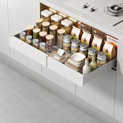 White under-sink pull-out cabinet organizer drawer with raised edge and spice jars shown inside