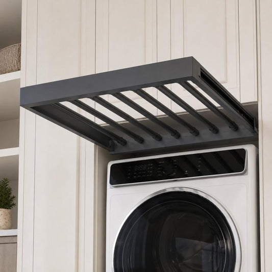 Dark gray extendable drying rack with multiple rods over a front-loading washer