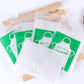 Assorted individually packed clear polyethylene disposable aprons with green headers