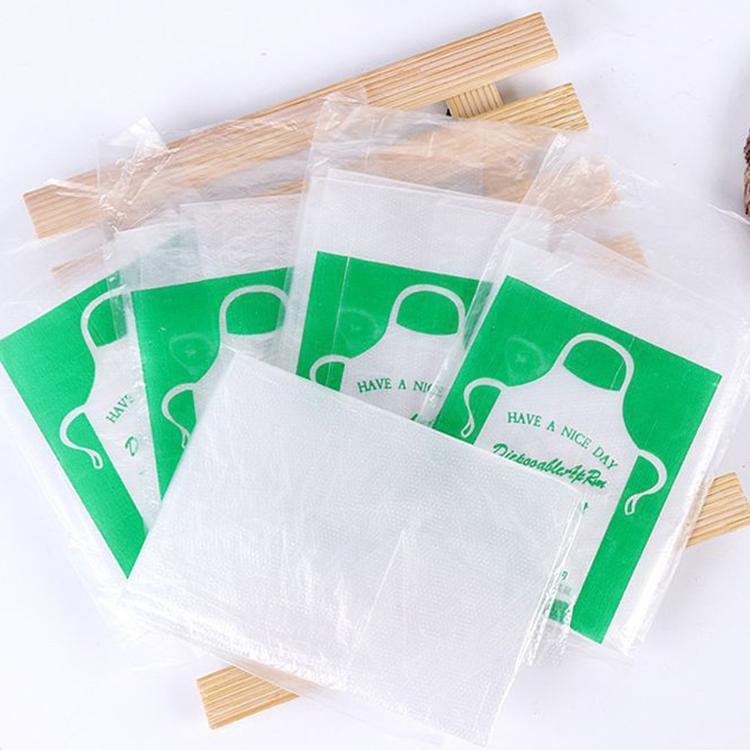 Assorted individually packed clear polyethylene disposable aprons with green headers