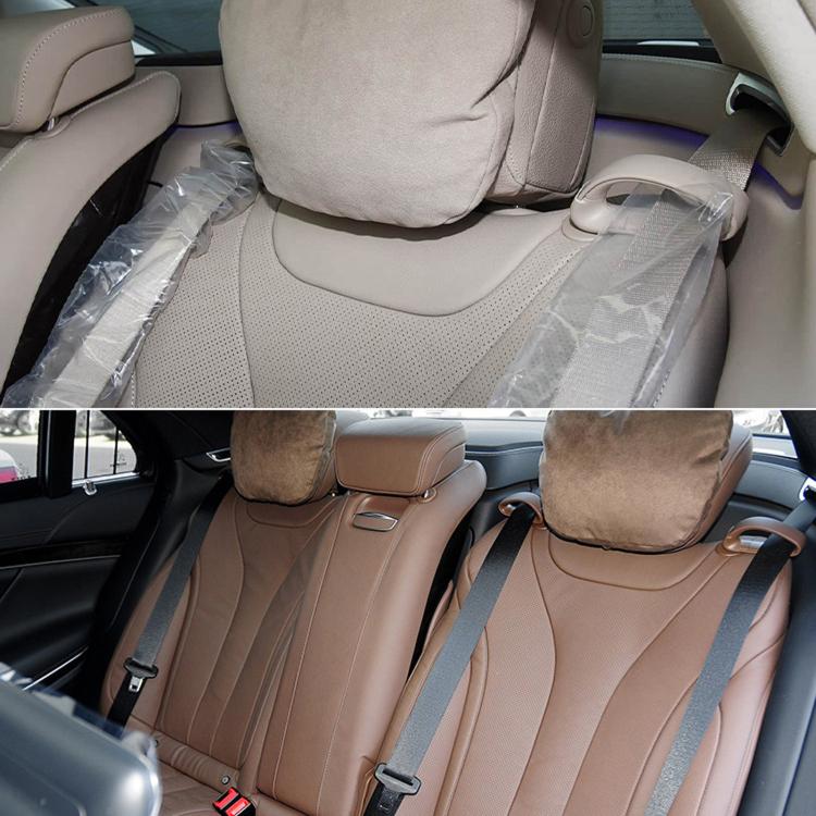 Brown rear seat belt guide clip set installed on beige leather seats