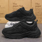 Men's black lace-up running sneakers, low-top style with chunky rubber outsole