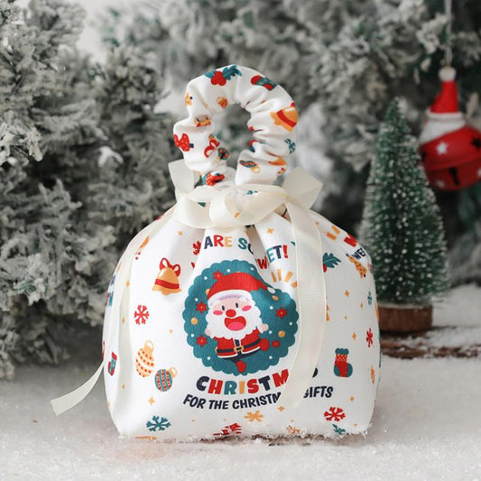 White fabric Christmas drawstring pouch with Santa face wreath and “CHRISTMAS GIFTS” text.