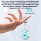 Teal bear-face personal alarm keychain held in a hand with metal ring clip
