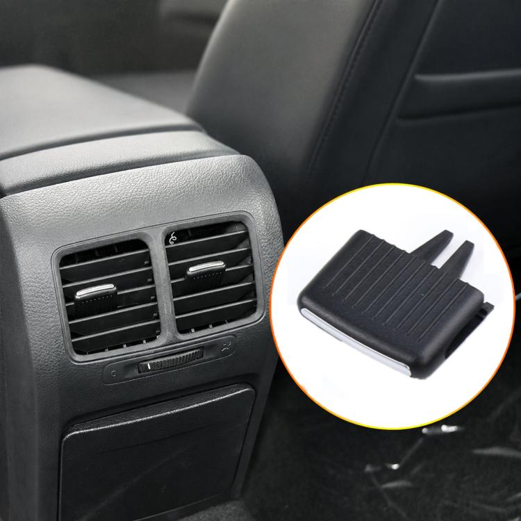 Black car AC vent grille paddle insert detail, ridged panel and side prongs