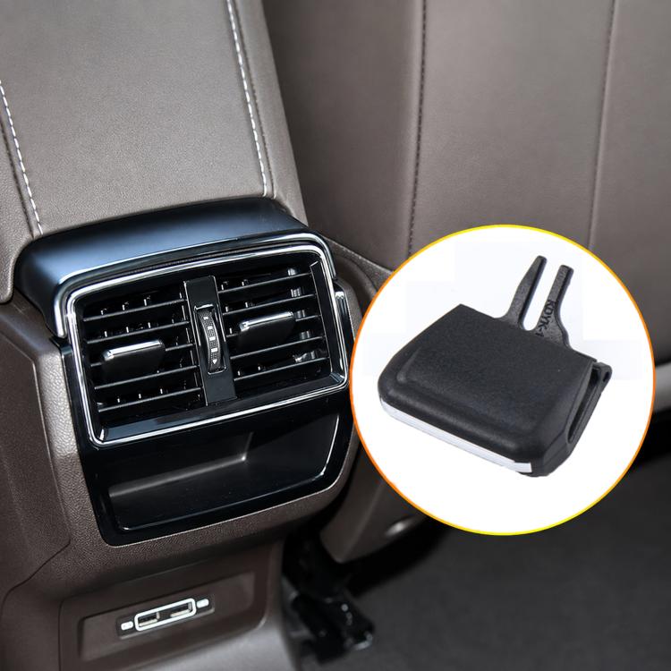 Black air vent grille paddle clip shown on car dashboard vent, with two prongs