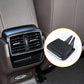 Black air vent grille paddle clip with two prongs, shown near dashboard vent