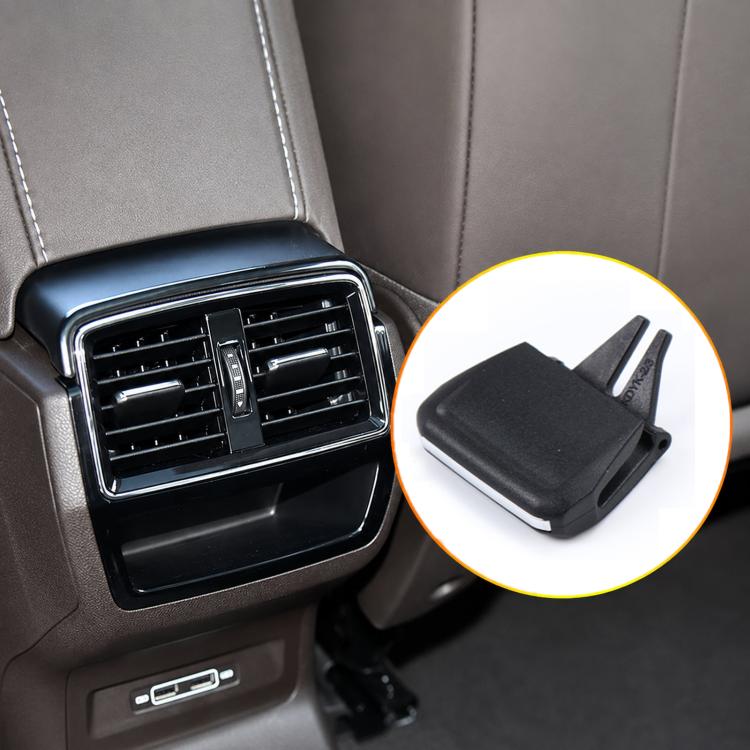 Black air vent grille paddle clip with two prongs, shown near dashboard vent